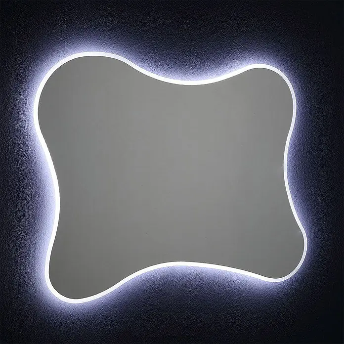 Kiamami Valentina Lichtspiegel - 25 x 750 cm, Farblos - Organisch geformter Spiegel mit weißer LED-Hintergrundbeleuchtung an einer dunklen, strukturierten Wand.