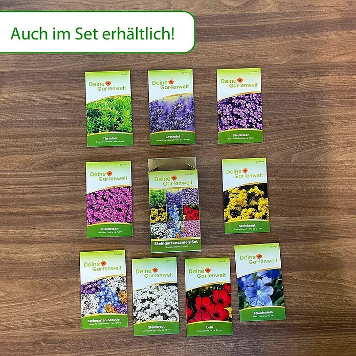Deine Gartenwelt Steinkraut Goldkörbchen -  - Neun Garten-Samenpäckchen und ein Steingarten-Samen-Set auf Holz. Zeigt verschiedene Blumen- und Kräutersamen.