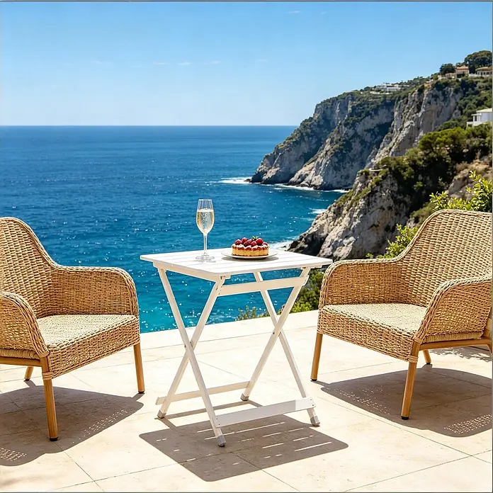 SONNENH Balkontisch klappbar 50,5 x 46,5 x 60 cm Silber aus Aluminium -  - Zwei natürliche Rattanstühle und ein weißer Klapptisch mit Getränk und Dessert auf einer sonnigen Terrasse am Meer.