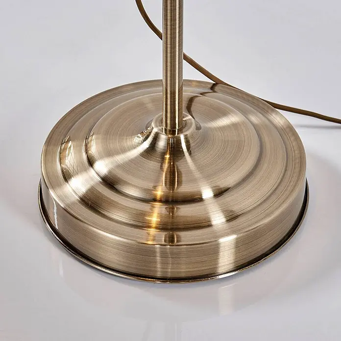 Lindby Stehleuchte Otis - bronze / altmessing, E27 - Gebürsteter Lampenfuß aus antikem Messing mit zentralem Rohr und sichtbarem Netzkabel.