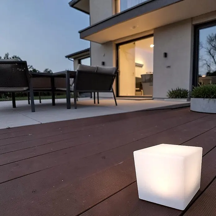 DAPO Solar-Dekoleuchte LED Solar-Leuchte Mate Würfel 30cm - L x B x H: 30 x 30 x 30 cm, Weiß, IP67 - Kleine, beleuchtete weiße Würfelleuchte auf dunklem Holzdeck, spendet stimmungsvolles Außenlicht.