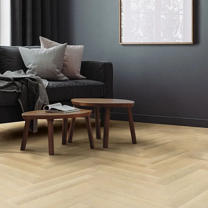 ML-Design Vinylboden 4 x Paket Vinylboden mit 80 Diele = 6,2464 m² - Braun, Landhausdiele - Heller Fischgrätparkettboden aus Holz in einem modernen Wohnzimmer mit dunklen Wänden und Sofa.