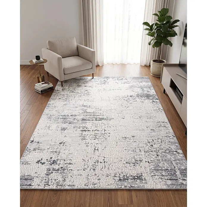 Alfombra de pelo corto Piel - Gris, 230 x 160 cm, 100% poliéster - Alfombra de área abstracta gris y blanca con efecto desgastado sobre suelo de madera en sala moderna.