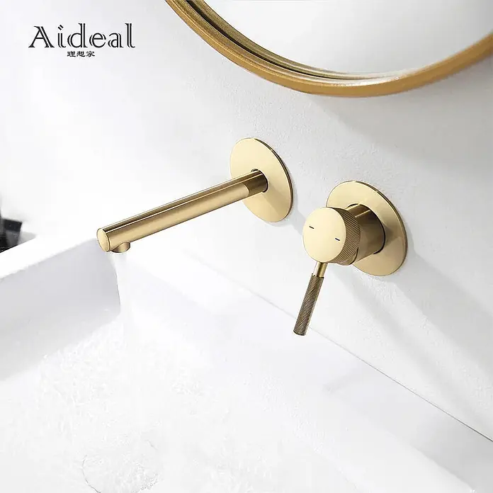Hudor Waschtischarmatur 7109 - Seidenmatt - Gebürstete goldene Wandarmatur mit separatem Hebelgriff, Wasser fließt in ein weißes Waschbecken.
