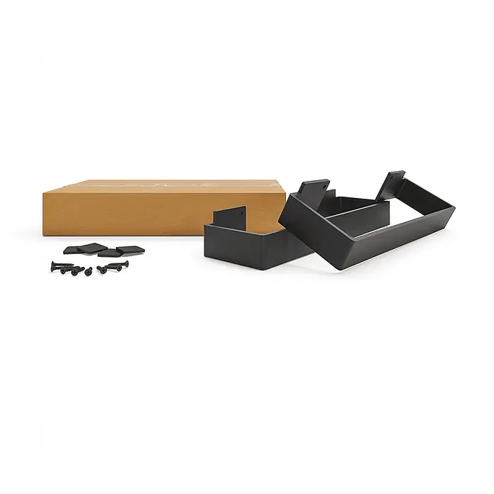 HEVVA Möbelfuß-Set LUXEMBURG - L x B x H: 25 x 4 x 10 cm, Metall, 2 Stk. - Bausatz mit braunem Karton, zwei schwarzen Rechteckrahmen, schwarzen Schrauben und Filzgleitern zur Montage.