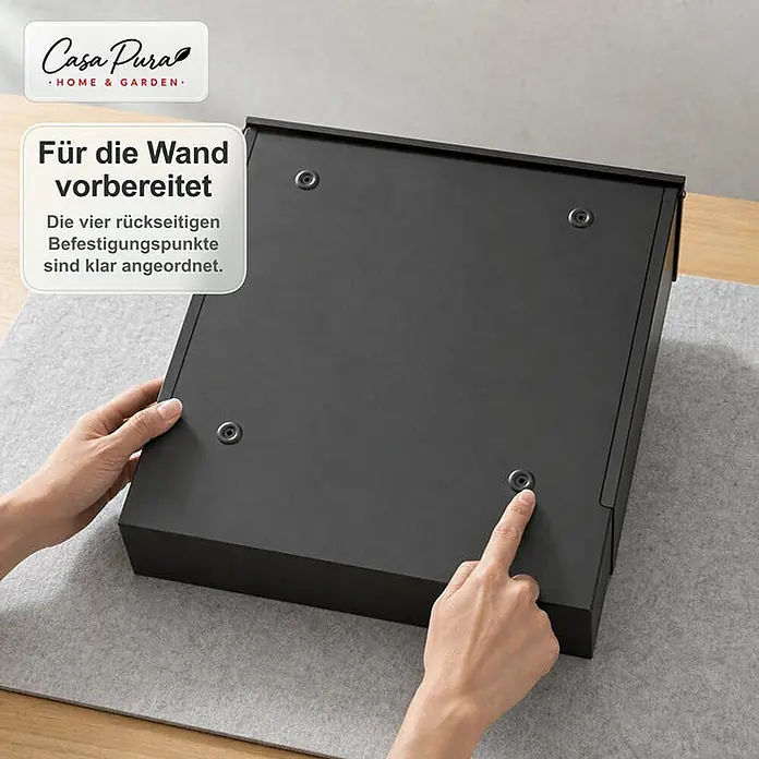 Floordirekt Wandbriefkasten Pascal - L x B x H: 10,5 x 37 x 37 cm, Anthrazit, Stahl, Zeitungsfach - Rückseite eines schwarzen wandmontierbaren Gegenstands mit vier Befestigungspunkten. Eine Hand zeigt auf einen der Punkte.