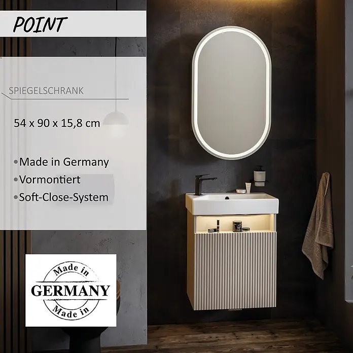Camargue Point LED-Spiegelschrank - B x H: 54 x 90 cm, Holz, Anthrazit, DIN Anschlag: Links - Ein beleuchteter ovaler Spiegelschrank über einem hellen Waschtisch mit weißem Waschbecken und schwarzem Wasserhahn in einem modernen Bad.