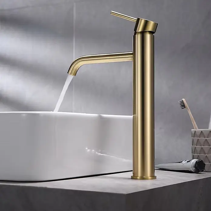 Hudor Waschtischarmatur Scamandre 7635 - Seidenmatt - Hoher goldener Badhahn gießt Wasser in ein weißes Aufsatzwaschbecken.