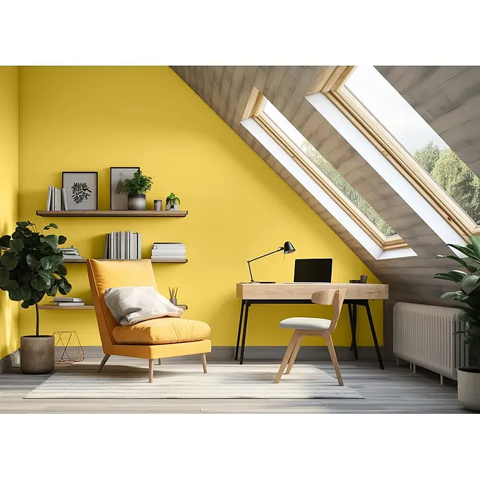 Caleo Color Wandfarbe Lehmfarbe Steppengras - Steppengras, Matt, 5 l - Helles Dachgeschoss-Homeoffice mit gelber Akzentwand, Holzschreibtisch, Stuhl und gemütlichem gelben Sessel unter Dachfenstern.
