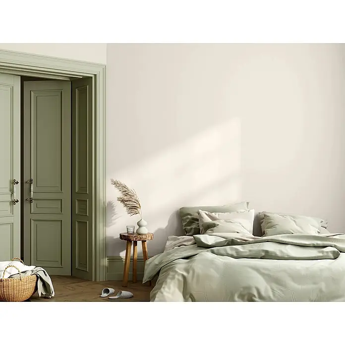 Caleo Color Wandfarbe Lehmfarbe Lammwolle - Lammwolle, Matt, 2,25 l - Bett mit hellgrünem Bettbezug und Kissen in einem ruhigen Schlafzimmer. Passende grüne Türen und Zierleisten.