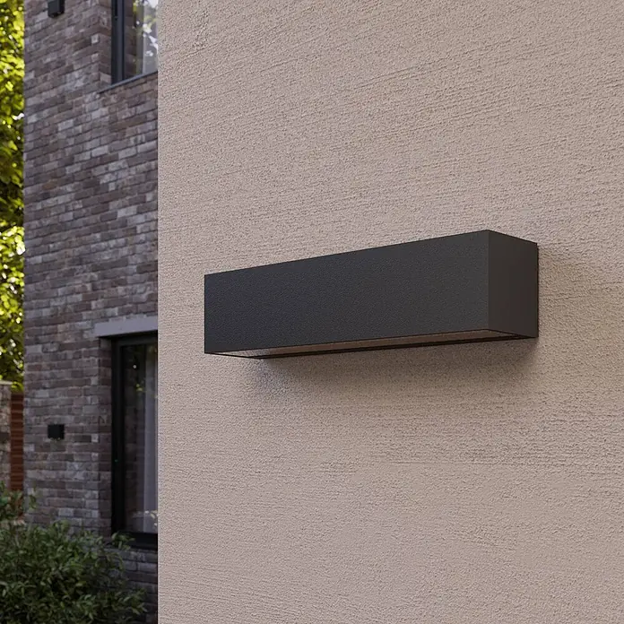 Lucande LED Wandlampe aussen grafitgrau, LED Wandleuchte außen, -  - Dunkelgraue rechteckige Außenwandleuchte an einer strukturierten beigen Wand, nach unten strahlend.
