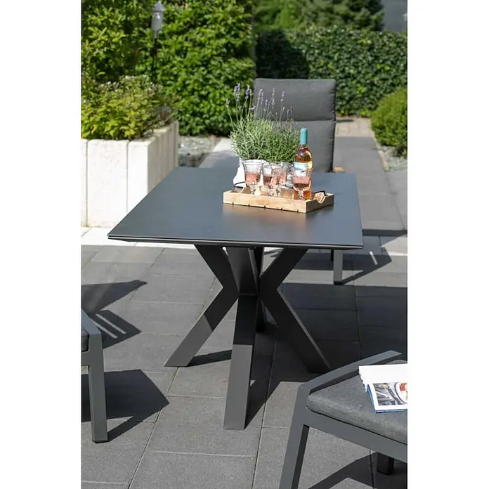 Bene Living Gartentisch Malaga - Aluminium Gestell mit gesinerter Tischplatte aus Keramik, Rechteckig, Anthrazit - Dunkelgrauer Gartentisch mit sternförmigem Gestell auf der Terrasse, mit Getränken und Lavendel, umgeben von Gartenstühlen.