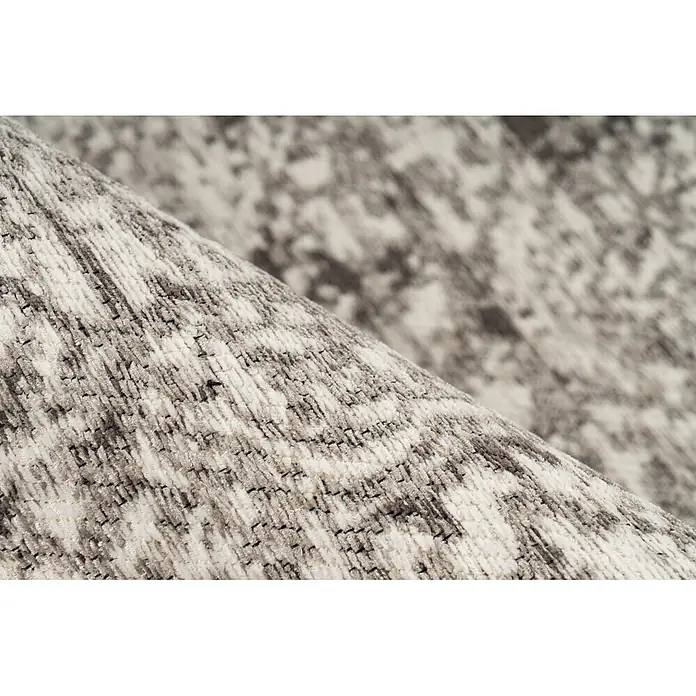 Kayoom Kurzflorteppich Davis 225 - Grau, 230 x 160 cm, 100 % Polyester - Nahaufnahme eines texturierten grau-weißen Teppichs mit Muster, teilweise gerollt.
