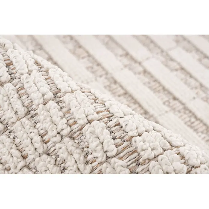 Kayoom Fransenteppich Reef 125 - Elfenbein, 150 x 80 cm, 100 % Polypropylen - Nahaufnahme eines gerollten, cremefarbenen und braunen Teppichs mit erhabenem Muster.