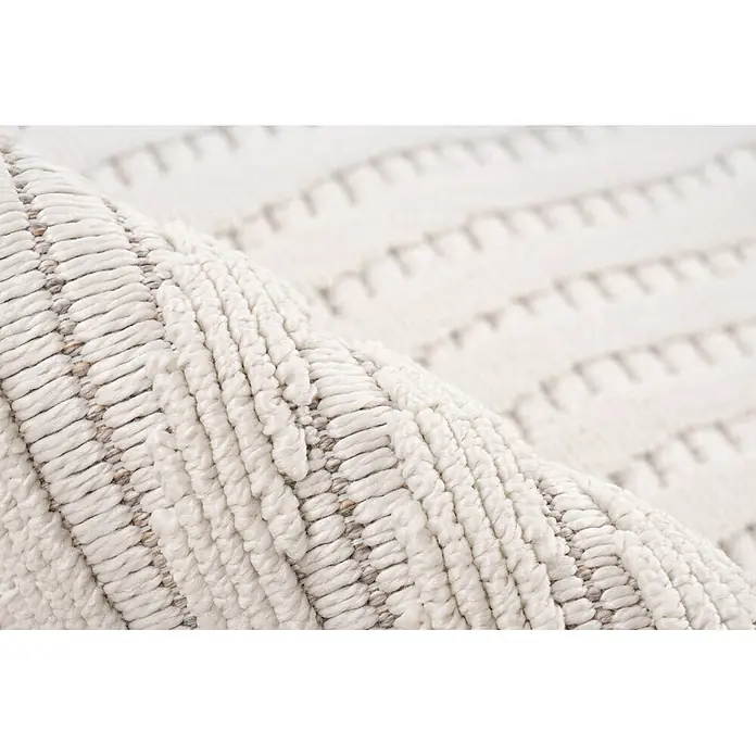 Kayoom Fransenteppich Reef 225 - Elfenbein, 150 x 80 cm, 100 % Polypropylen - Nahaufnahme eines cremefarbenen Teppichs mit dicker, gewebter Textur.