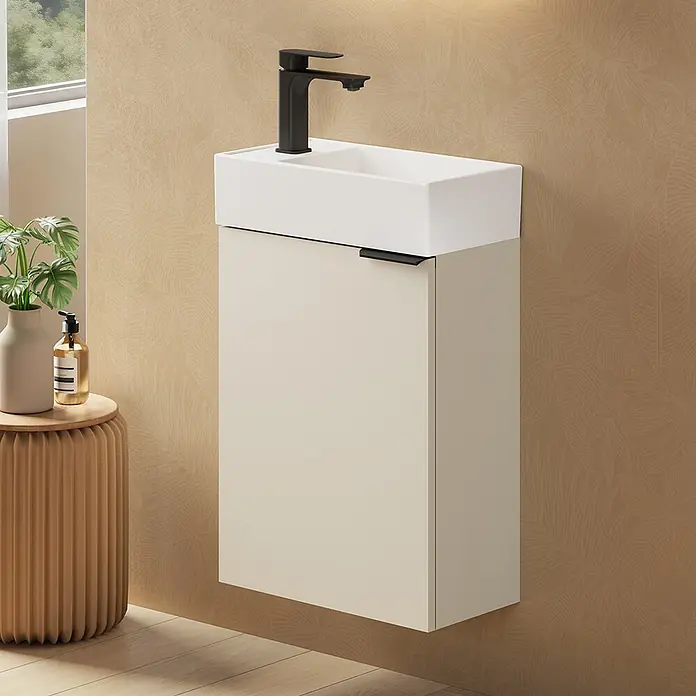 Emke Badmöbel-Set BV1 - Soft Cashmere Grau - Ein hellbeiger, wandmontierter Waschtischunterschrank mit weißem rechteckigem Waschbecken und schwarzem Wasserhahn in einem modernen Bad.