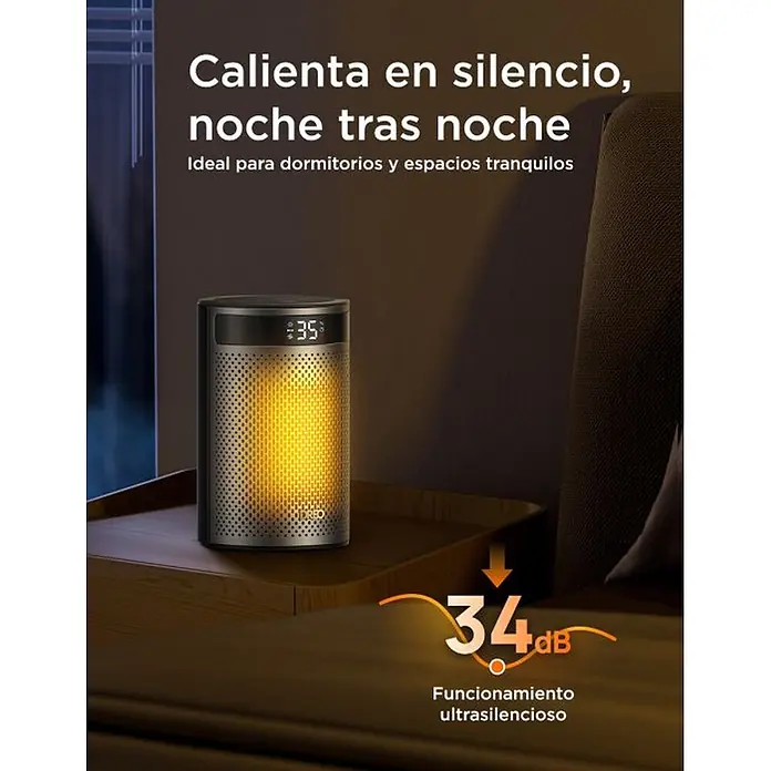 Dreo Calefactor cerámico portátil Atom - 900 kW - 1.500 kW, Negro/Plata, Fijo, 10 m² - 20 m² - Calefactor cilíndrico gris oscuro con elemento incandescente naranja sobre una mesita de noche de madera. Funcionamiento silencioso para dormitorios.