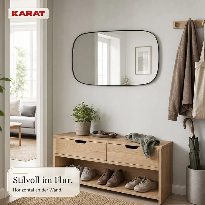 Floordirekt Wandspiegel Alina - 55,1 x 90,1 cm - Abgerundeter rechteckiger Spiegel mit schwarzem Rahmen, horizontal über einer hellen Holz-Schuhbank.
