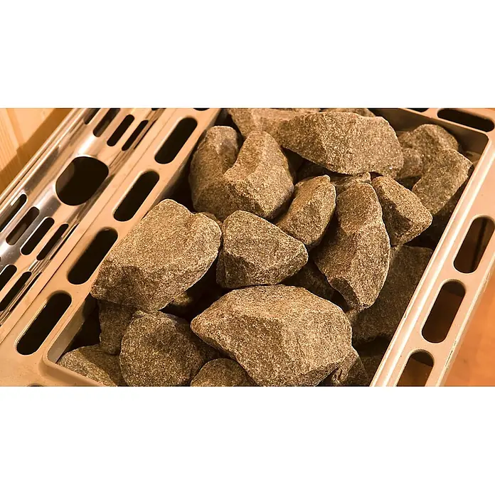 Weka Saunaofen-Set Set 5 - 3,6 kW, Raumheizvermögen: 1 m³ - 5 m³ - Raue, naturfarbene grau-braune Saunasteine füllen einen Metall-Heizkorb.