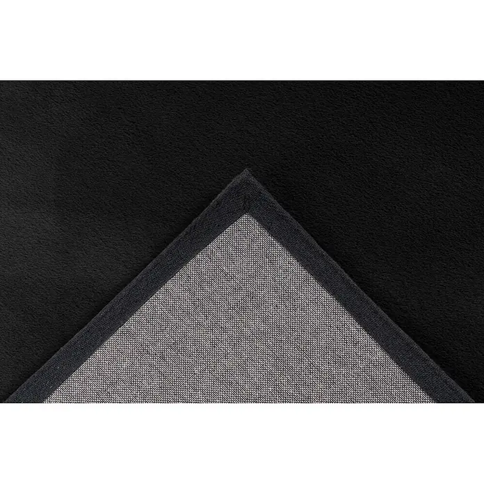 Kayoom Fellteppich Cross 425 - Graphit, 230 x 160 cm, 100 % Polyester - Schwarzer Plüschteppich mit umgeschlagener Ecke, die die graue, gewebte Unterseite zeigt.
