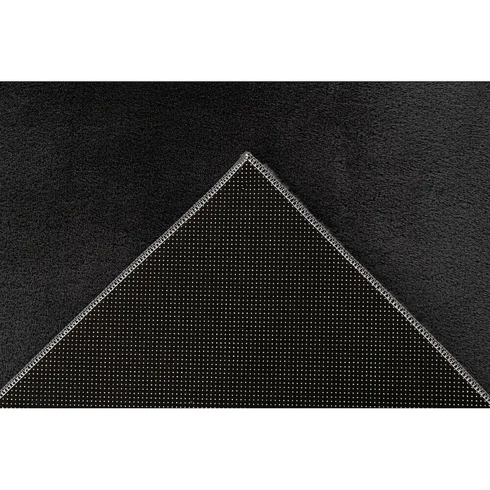 Kayoom Fellteppich Emperor 525 - Graphit, 150 x 80 cm, 100 % Polyester - Dunkelgrauer, weicher Teppich, teilweise umgeschlagen, um seine rutschfeste Rückseite mit weißen Punkten zu zeigen.