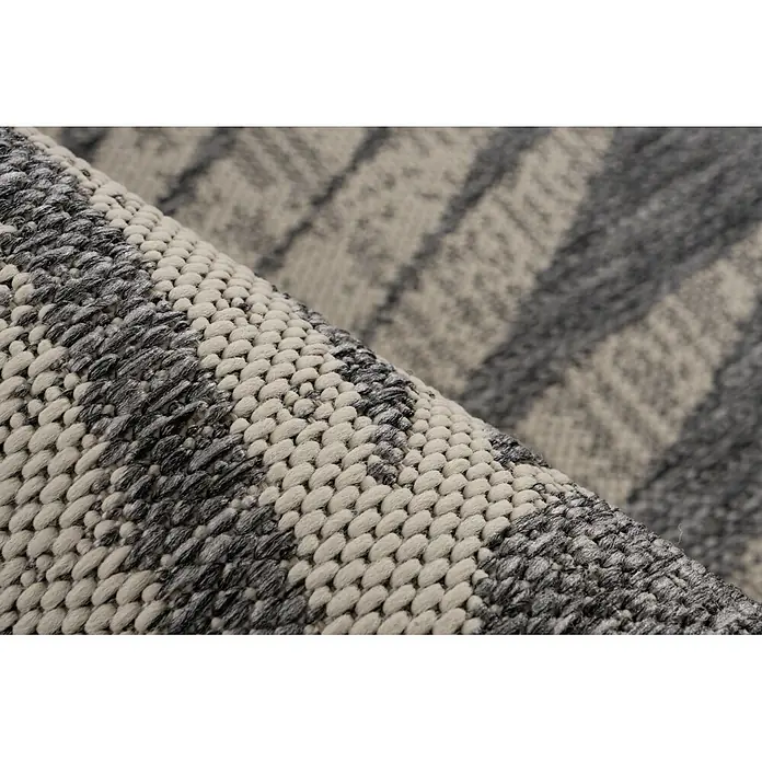 Kayoom Outdoor-Teppich Nibru 725 - Silber, 230 x 160 cm, 100 % Polypropylen - Teilweise gerollter Teppich mit grober Webstruktur in hell- und dunkelgrauen Streifen.