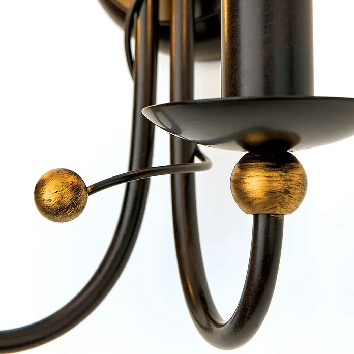 Orion Leuchten Wandleuchte - 40 W, L x B x H: 15 x 24 x 24 cm, E14 - Nahaufnahme einer Leuchte aus antikem Bronze mit goldfarbenen Kugelakzenten und Kerzenhalterung.
