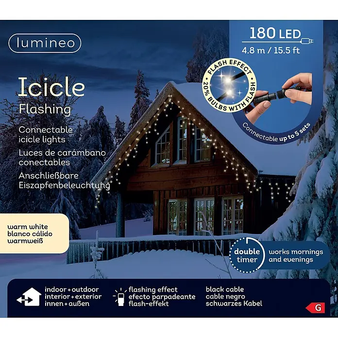 Lumineo Cascada de luz LED Icicle - Para exterior, 4,8 m, Blanco cálido, 180 ud., Funcionamiento en red - Luces LED de carámbano blanco cálido con cable negro, decorando una casa en un paisaje invernal nevado.