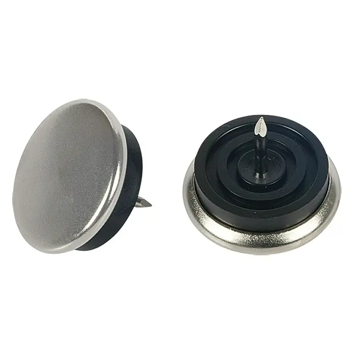 Stabilit Taco de teflón para patas - Diámetro: 30 mm, Metal, Redonda, 4 ud. - Primer plano de dos deslizadores de muebles para clavar y facilitar su colocación en las patas de sillas y mesas, protegiendo los suelos de arañazos.