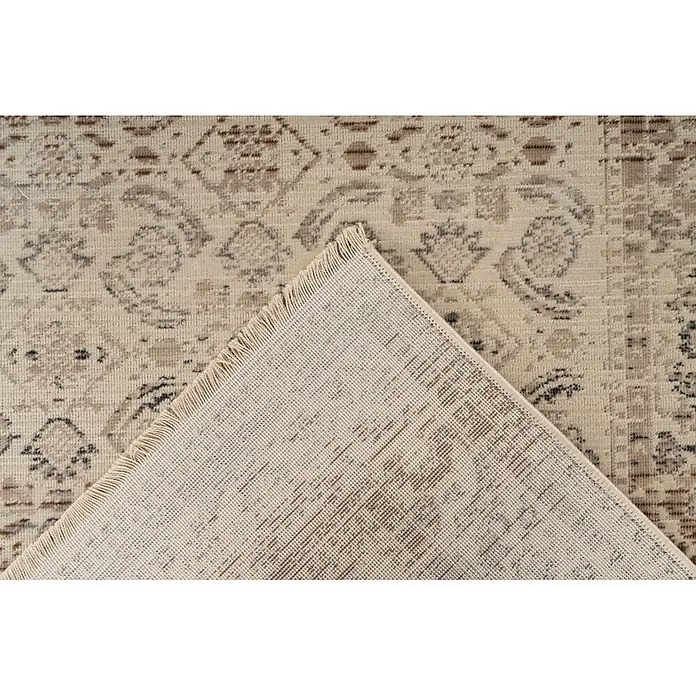 Kayoom Kurzflorteppich Charin 625 - Beige, 150 x 80 cm, 100 % Polypropylen - Heller beiger Teppich mit verwaschenem Braun/Grau-Muster, umgeklappt, um die gewebte Rückseite und Fransen zu zeigen.