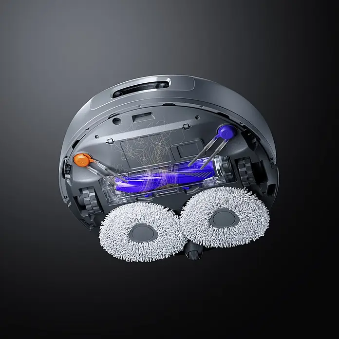 Narwal Saugwischroboter Freo Z10 ultra Extend - Saugkraft: 18.000 Pa, Akkulaufzeit: 150 min, Fassungsvermögen Roboter: 2.500 ml - Unterseite eines grauen Saugroboters: transparenter Saugkanal, blaue Bürstenwalze, weiße Mopppads und Seitenbürsten, aktiv Schmutz saugend.