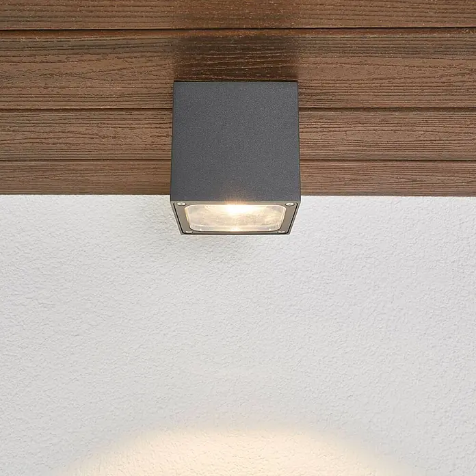Lucande LED Outdoor Deckenlampe in dunkelgrau, transparent, Deckenleuchte -  - Quadratische dunkelgraue Außenleuchte, an einer Holzdecke montiert, die ein warmes Licht nach unten wirft.