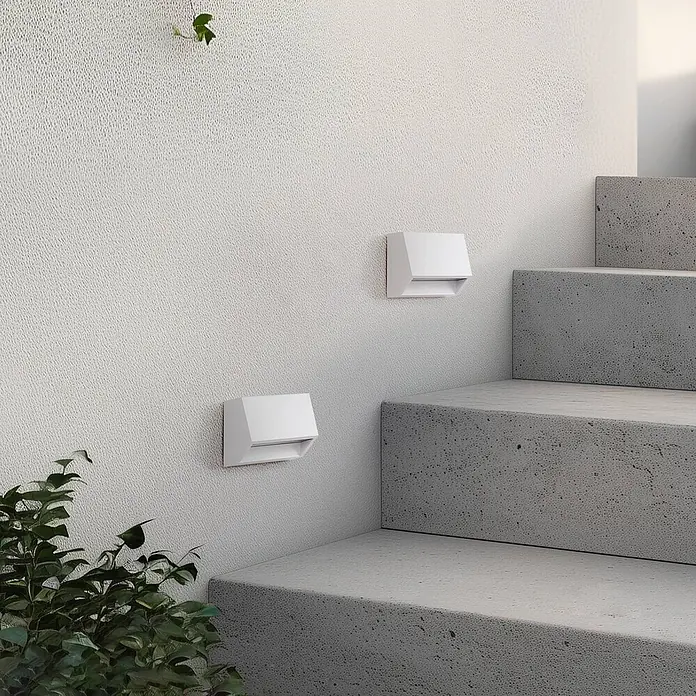 Lindby LED Wandleuchte aussen in weiß, Aussenlampe Wand -  - Zwei weiße, geometrische Wandleuchten an einer strukturierten Wand, die Betontreppen dezent beleuchten.