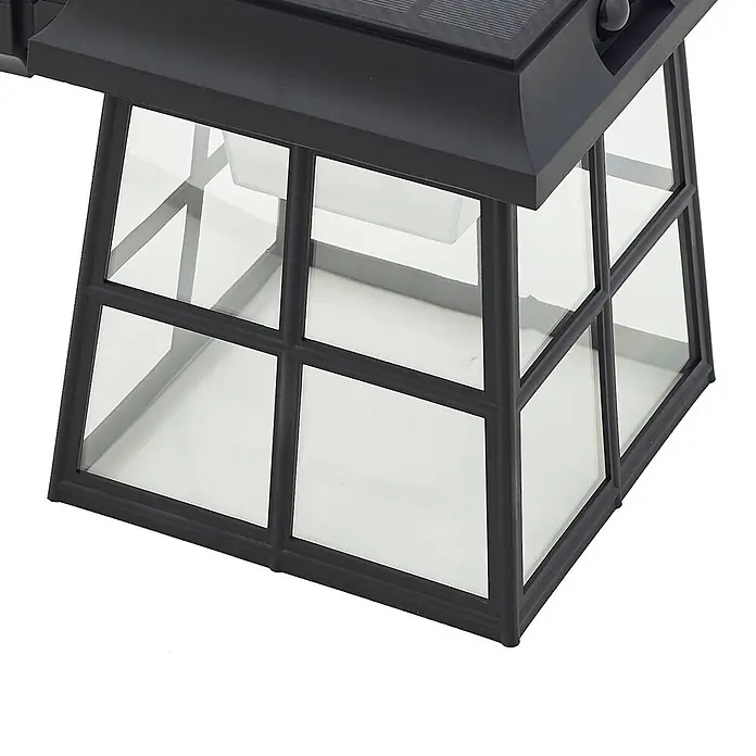 Lindby LED Solar Wandleuchte aussen in schwarz, mit Bewegungsmelder, -  - Schwarze Solar-Außenlaterne mit Klarglasfeldern und einem Oberteil mit Solarpanel.