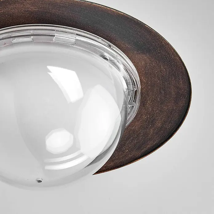 Lindby Edelstahl LED Wandlampe aussen Antik Look, LED Wandleuchte außen -  - Klarglas-Kuppel und eine rustikale bronzefarbene Metallbasis einer Leuchte.