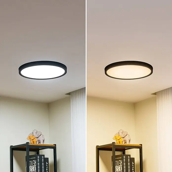 Lindby LED Deckenlampe Smart Home in schwarz matt, weiß, dimmbar -  - Runde schwarze Deckenleuchte, die kaltweißes und warmweißes Licht in einem Raum zeigt.