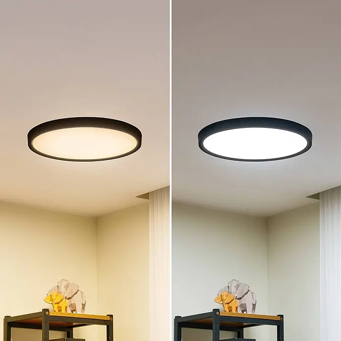 Lindby LED Deckenlampe in schwarz matt, weiß, Deckenleuchte rund -  - Runde schwarze LED-Deckenleuchte zeigt warmweißes (links) und kaltweißes (rechts) Licht in einem Raum.
