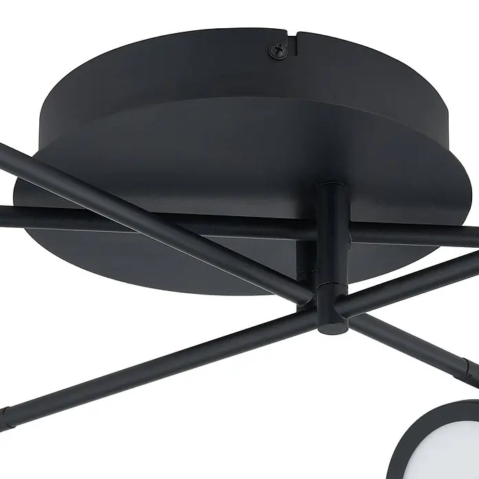 Lindby Deckenleuchte Manel - schwarz, schwarz - Mattschwarze Deckenleuchte mit runder Montageplatte und mehreren sich kreuzenden Metallarmen. Eine Schraube ist sichtbar.