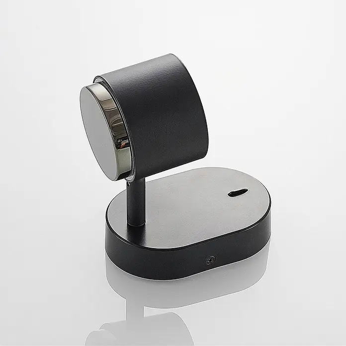 Lindby LED Deckenlampe in schwarz, Deckenstrahler -  - Schwarzer Smartwatch-Ladeständer mit ovaler Basis und silbernem Magnetpuck.