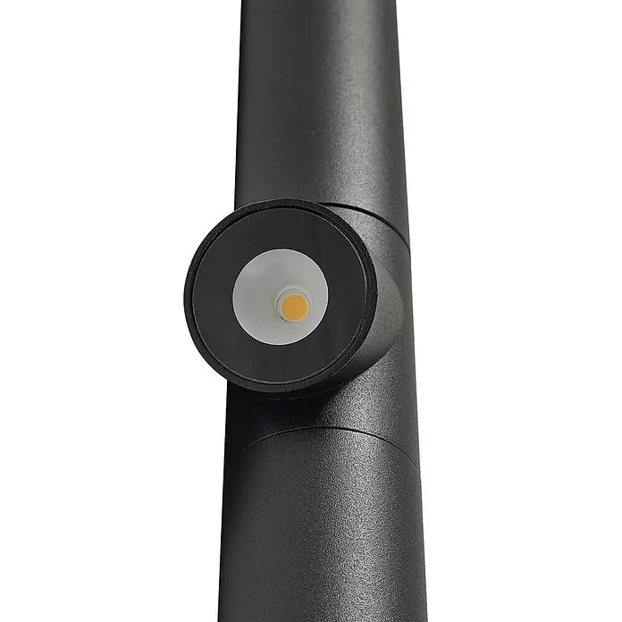 Lindby Erdspießleuchte Luzian -  - Schwarze zylindrische Außenleuchte mit texturierter Oberfläche und integrierter LED-Lichtquelle an der Seite.
