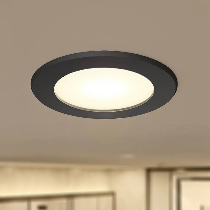 PRIOS LED Einbauleuchte Decke in schwarz, Einbaustrahler -  - Beleuchtete runde schwarze LED-Einbauleuchte an der Decke, die einen Raum erhellt.