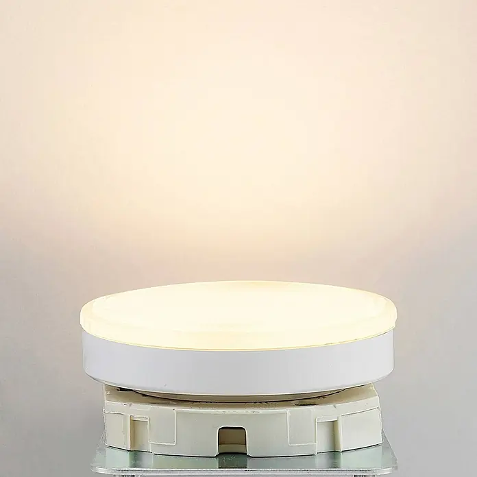 Arcchio Leuchtmittel -  - Runde weiße LED-Panel-Leuchte strahlt warmweißes Licht aus, auf weißem Sockel montiert.