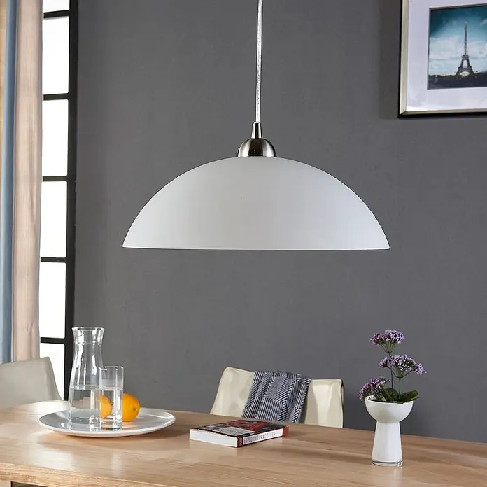 Lindby Esstisch Pendelleuchte Glas Metall, Hängelampe 1 flammig, -  - Weiße, halbrunde Pendelleuchte aus satiniertem Glas mit gebürsteter Metallhalterung über einem Esstisch.