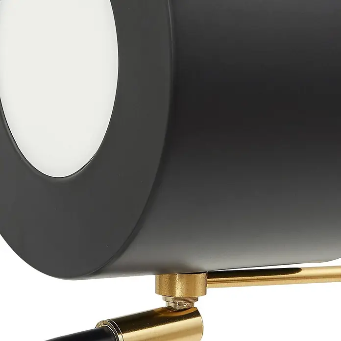 Lindby Stehlampe Wohnzimmer in schwarz, Stehleuchte -  - Nahaufnahme einer schwarzen zylindrischen Leuchte mit weißem Diffusor, befestigt an einem Messingarm.