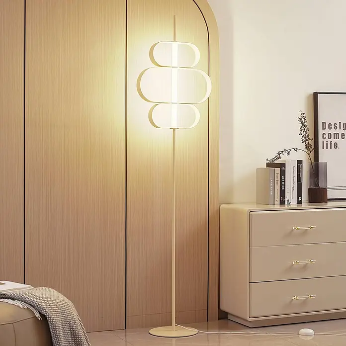 Lucande LED Stehlampe Wohnzimmer in beige, weiß, Stehleuchte -  - Eine moderne, hohe, cremefarbene Stehlampe mit gestapelten ovalen Diffusoren, die warmes Licht in einen modernen Raum wirft.