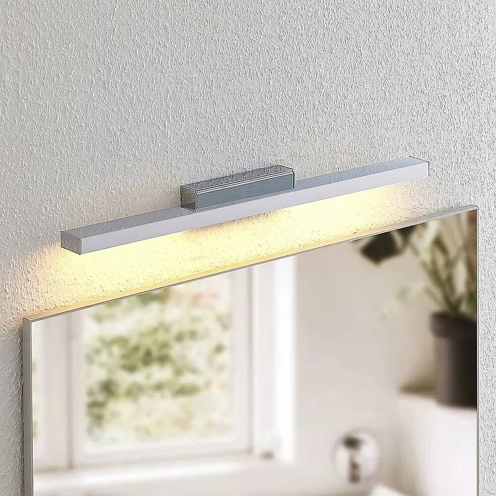 Lindby LED Wandleuchte innen in weiß, chrom, Wandlampe -  - Moderne, lineare LED-Spiegelleuchte in Chromoptik, warmweißes Licht abstrahlend, über einem Spiegel montiert.
