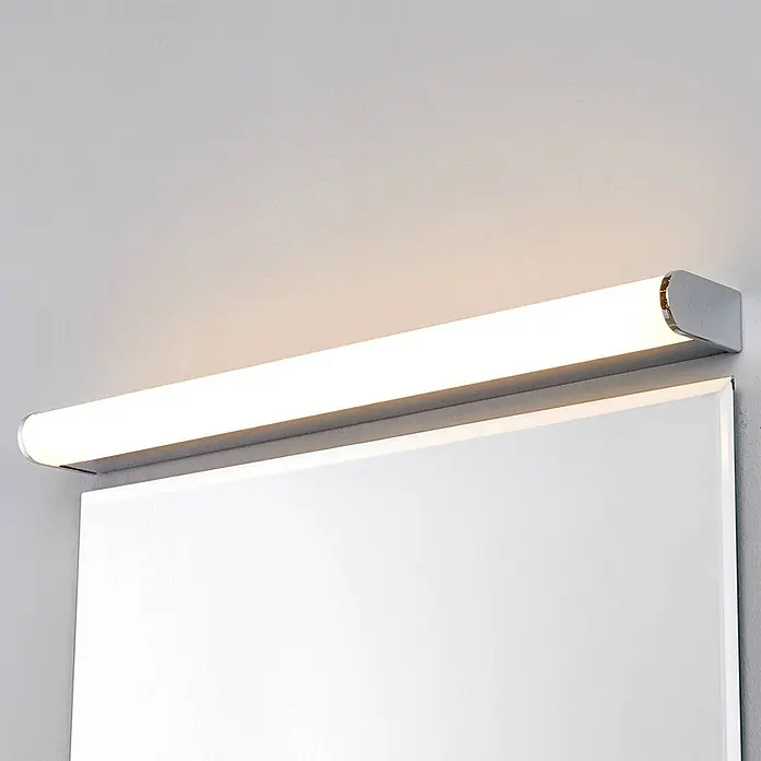 Lindby LED Wandleuchte innen in chrom, weiß, Wandlampe -  - Silberne lineare LED-Spiegelleuchte mit warmem Licht, über einem Spiegel montiert.