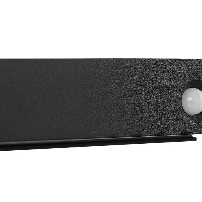 Lucande Außenwandleuchte Tavon - schwarz, schwarz, IP54 - Nahaufnahme einer schwarzen strukturierten Platte mit weißem kugelförmigem Sensor rechts.