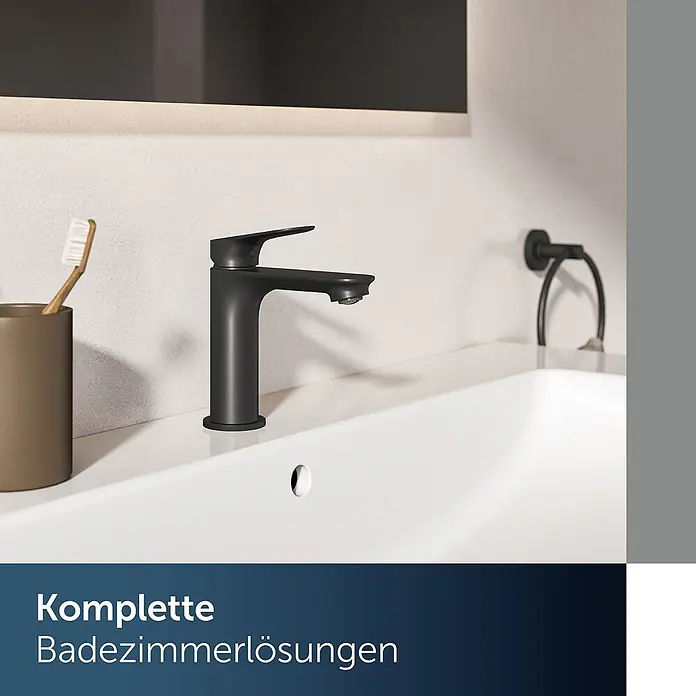 Ideal Standard Waschtischarmatur - Matt Schwarz, Matt - Mattschwarze Armatur in modernem Badwaschbecken, daneben Zahnbürste und Handtuchring.