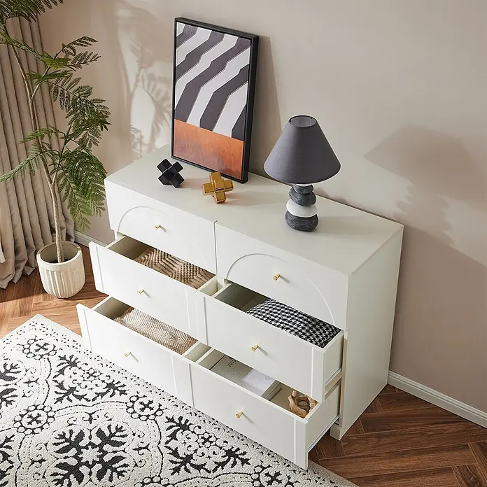 SONNENH Kommode mit 6 Schubladen und Bogenfront, Weiß -  - Weiße Kommode mit sechs Schubladen, einige offen, die Stauraum zeigen. Mit goldenen Knöpfen und modernem Design in einem Raumambiente.